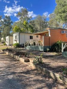 a house with a garden in front of it at Sandy Hollow Tourist Retreat in Sandy Hollow