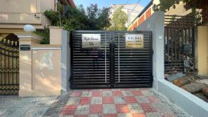 a black garage door with two signs on it at Elegant & Luxurious Villa at Film Nagar, Jubilee Hills near Apollo in Hyderabad