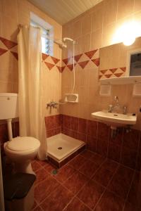 a bathroom with a toilet and a sink at Stella Studios in Laganas