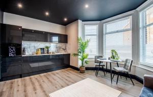 a kitchen and dining room with a table and chairs at The Rampart in Great Yarmouth