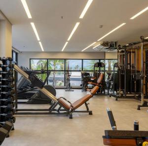 a gym with a treadmill and a elliptical machine at Salinas Premium Resort in Salinópolis