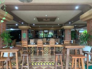 a restaurant with wooden tables and chairs and a bar at SouthLinks Country Club in Nagoya