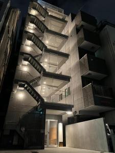 a large building with lights on the side of it at Hotel Apreton in Tokyo +37 photos