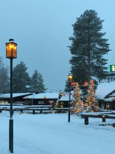 a park with benches and lights in the snow at Aurora-Center 1 in Rovaniemi