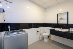 a white bathroom with a sink and a toilet at 2R2B/Harmony Sunrise/1~8pax/Gurney/Mansion One in George Town +19 photos