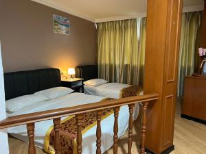 Postel nebo postele na pokoji v ubytování Hotel Ching Hua