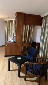 a living room with a chair and a table at Hotel Ching Hua in Segamat