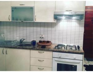 a kitchen with a sink and a stove top oven at Studio apartment beach front in Harqalah +2 photos