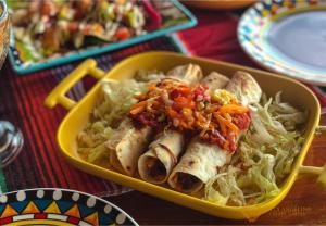 a yellow container of food with meat and vegetables at Villa Angelina Luxury Suites in Dapitan