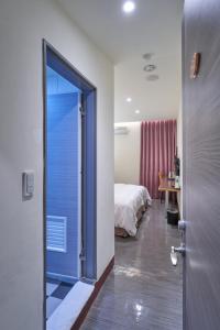 a door leading to a bedroom with a bed at Yung An Business Hotel in Dounan
