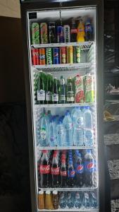 um frigorífico cheio de água e bebidas em Aminabonu Hotel em Samarcanda