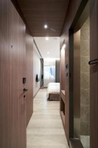 a hallway leading to a bedroom with a bed at Yung An Business Hotel in Dounan