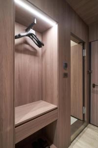 a walk in closet with a wooden wall at Yung An Business Hotel in Dounan