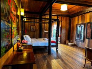 a bedroom with a bed in a room with wooden walls at Chef Nak Luxury Homestay in Phnom Penh