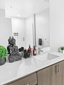 a kitchen with a statue of a woman sitting on a counter at Highrise the Heart of Downtown in Phoenix