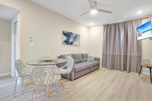 a living room with a couch and a table and chairs at Elegant Brickell Miami Apartment in Miami