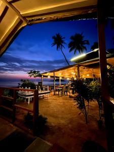 a restaurant with a view of the ocean at night at Palolem Beach View Inn in Palolem