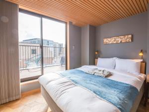 Rúm í herbergi á Asakusa Kokono Club Hotel