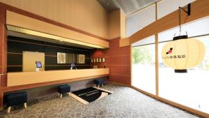 a lobby with a reception desk in a building at Yutorelo Nasushiobara in Nasushiobara