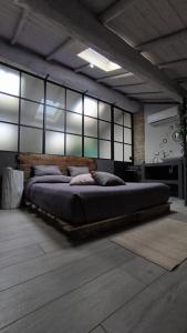 a bedroom with a large bed with a wooden headboard at La Rosa Dei Venti in Manerbio +146 photos
