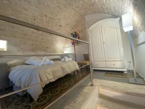 a bedroom with a bed and a white cabinet at Residenza Le Tre Volte - colazione inclusa con TicketBar in Martina Franca +61 photos