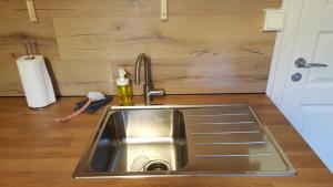 a stainless steel sink in a kitchen with a counter at Rosa's stuga 