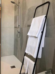 a shower with white towels hanging on a rack at LAUS VIA SPARANO APP.2- LUX & DESIGN NEW! in Bari