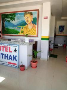 a large painting of a buddha on a wall in a building at Hotel Kanthak in Lumbini