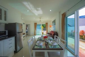 - une cuisine et une salle à manger avec une table et des chaises dans l'établissement Star 2 BR Private Pool Villa - Chalong, à Chalong