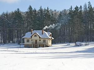 a house with snow on top of it in a field at Kazikówka 