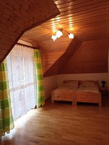 a bedroom with a bed in a attic at Kazikówka 