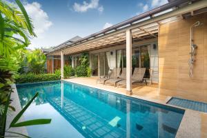 a swimming pool in the backyard of a house at Dalaa 9 in Kamala Beach