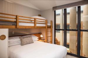 a bedroom with two bunk beds and a window at Reflections Seal Rocks - Holiday Park in Smiths Lake