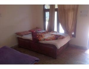 Llit o llits en una habitació de Hotel Krish Motel and Restaurant, Uttarkashi