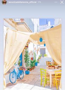 a blue bike parked on a patio with tables and chairs at Welcome Friends&Family in Ceglie Messapica