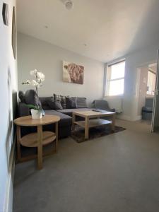 a living room with a couch and a table at Eclipse Apartment No 1 in Newmarket