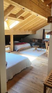 a bedroom with two beds and a wooden ceiling at Arsa Lodge Silvaplana in Silvaplana