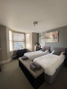 a bedroom with two beds and a window at Eclipse Apartment No 1 in Newmarket