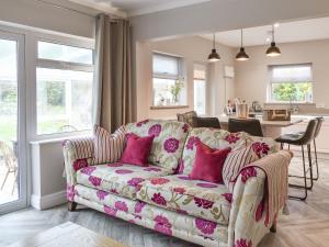 a living room with a couch with pink pillows at Willow Cottage in Conwy