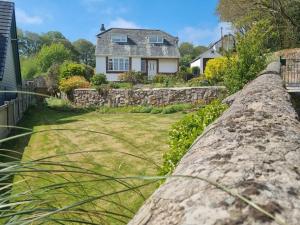 a stone wall in front of a house at Willow Cottage in Conwy