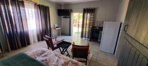 a kitchen with a table and chairs and a refrigerator at Van Zyls Hoek in Vryburg