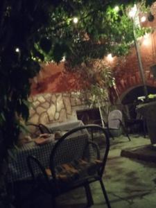 a bench sitting in front of a stone wall at Apartman i Sobe Čule Cres in Cres