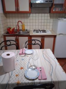 a kitchen with a table with a table cloth on it at Apartman i Sobe Čule Cres in Cres