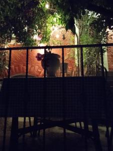 a bench sitting in front of a fence at Apartman i Sobe Čule Cres in Cres
