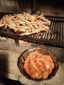 a bunch of food is cooking on a grill at Apartman i Sobe Čule Cres in Cres