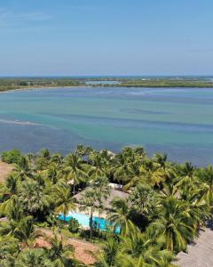 an aerial view of a resort with palm trees and the water at The Rascals Kite Resort in Kalpitiya