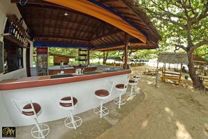 a bar with stools in front of a building at Casa Astillero - Calatagan Batangas Private Resort in Calatagan