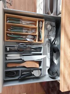 a drawer filled with knives and other kitchen utensils at Kesklinna peatuspaik in Tallinn