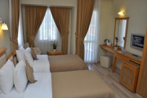Postel nebo postele na pokoji v ubytování Hotel Doruk