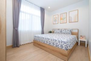 a bedroom with a bed and a large window at 2BR Homey townhome 350M walk to Kata Beach Fully equipped in Kata Beach